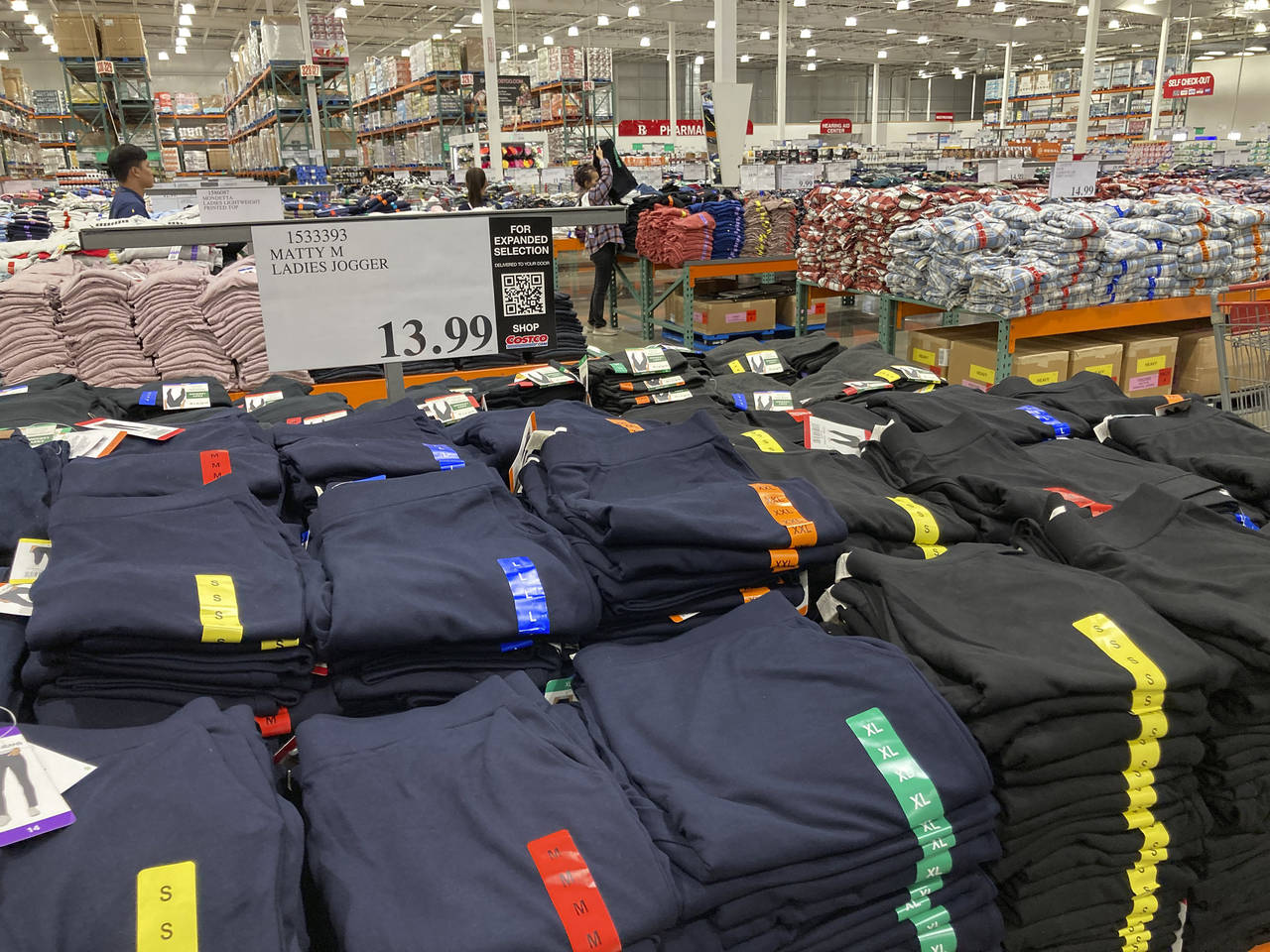 FILE - Clothing sits on tables for shoppers in a Costco warehouse Monday, Aug. 29, 2022, in Sherida...