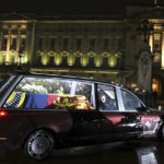 
              The hearse carrying the coffin of Queen Elizabeth II arrives at Buckingham Palace, London, Tuesday, Sept. 13, 2022, from where it will rest overnight in the Bow Room. (Paul Childs/Pool Photo via AP)
            