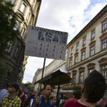 
              The banner gives "the worst grade to politicians in empathy, toleration and cooperation". Hungarian students protest in solidarity with their teachers in front of the St. Stephen's Basilica in Budapest, Hungary, Friday, Sept. 2, 2022. Public schools in Poland and Hungary are facing a shortage of teachers at a time when both countries are taking in many Ukrainian refugee children. For years, teachers have been fleeing public schools over grievances regarding low wages and a sense of not being valued by their governments. (AP Photo/Anna Szilagyi)
            