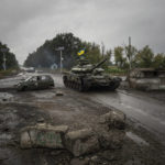 
              A Ukrainian tank drives past former Russian checkpoint in the recently retaken area of Izium, Ukraine, Friday, Sept. 16, 2022. (AP Photo/Evgeniy Maloletka)
            