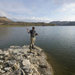 
              Nick Gann fishes Friday, Aug. 5, 2022, on the far northeastern shore of Flaming Gorge Reservoir, in Wyoming. A boating and fishing paradise on the Utah-Wyoming line, Flaming Gorge is beginning to feel the effects of the two-decade megadrought gripping the southwestern U.S. (AP Photo/Rick Bowmer)
            