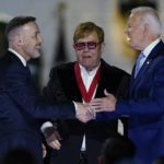 
              President Joe Biden greets David Furnish, husband of Elton John, after Biden presented him with a National Humanities Medal after a concert on the South Lawn of the White House in Washington, Friday, Sept. 23, 2022. (AP Photo/Susan Walsh)
            
