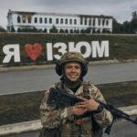 
              A Ukrainian soldier smiles in front of a city sign reading ''I Love Izium'' in Izium, Kharkiv region, Ukraine, Tuesday, Sept. 13, 2022. Ukrainian troops piled pressure on retreating Russian forces Tuesday, pressing deeper into occupied territory and sending more Kremlin troops fleeing ahead of the counteroffensive that has inflicted a stunning blow on Moscow's military prestige. (AP Photo/Kostiantyn Liberov)
            