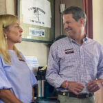 
              Georgia Gov. Brian Kemp, center, laughs with his wife Marty Kemp as Stephens County Commissioner Dennis Bell, right, introduces Kemp for a speech on Thursday, Aug. 4, 2022 in Toccoa, Ga. Republicans in Georgia increasingly rely on voters in north Georgia as their margins shrink in suburban Atlanta. (AP Photo/Jeff Amy)
            