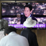 
              People watch a TV screen showing an image of South Korean actor Lee Jung-jae during a news program at the Seoul Railway Station in Seoul, South Korea, Tuesday, Sept. 13, 2022. (AP Photo/Ahn Young-joon)
            