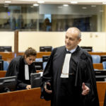 
              Felicien Kabuga's defence lawyer Emmanuel Altit, left, speaks with prosecutor Rupert Elderkin in court at the UN International Residual Mechanism for Criminal Tribunals (IRMCT) in The Hague, Thursday, Sept. 29 2022. Kabuga, who is accused of encouraging and bankrolling the country's 1994 genocide, goes on trial at a United Nations tribunal Thursday, nearly three decades after the 100-day massacre left 800,000 dead. (Koen van Weel/Pool Photo via AP)
            