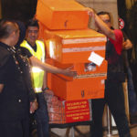 
              FILE - Police prepare to load confiscated items into a truck at the apartments linked to former Prime Minister Najib Razak. in Kuala Lumpur, Malaysia on May 18, 2018. Former first lady Rosmah Mansor was convicted Thursday, Sept. 1, 2022, of soliciting and receiving bribes during her husband’s corruption-tainted administration Thursday, a week after her husband was imprisoned over the massive looting of the 1MDB state fund (AP Photo, File)
            