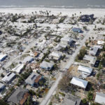 
              CORRECTS DATELINE TO FORT MYERS BEACH, NOT FORT MYERS - This aerial photo shows damaged homes and debris in the aftermath of Hurricane Ian, Thursday, Sept. 29, 2022, in Fort Myers Beach, Fla. (AP Photo/Wilfredo Lee)
            