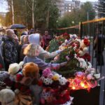 
              People gather to lay flowers and toys and light candles after the shooting at school No. 88 in Izhevsk, Russia, Monday, Sept. 26, 2022. Authorities say a gunman has killed 15 people and wounded 24 others in the school in central Russia. According to officials, 11 children were among those killed in the Monday morning shooting. (AP Photo/Sergei Kuztsov)
            