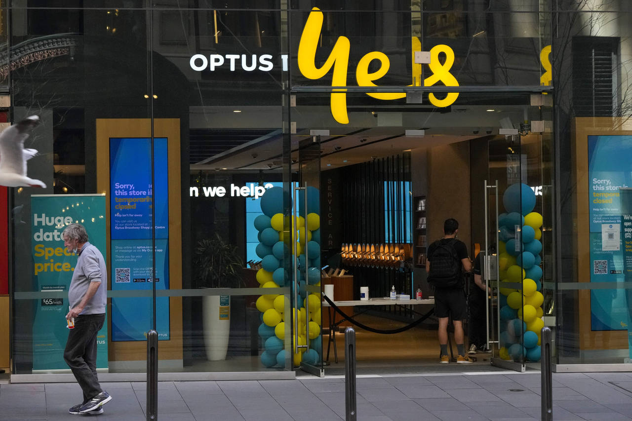 FILE - A customer waits for service at a Optus phone store in Sydney, Australia, Thursday, Oct. 7, ...