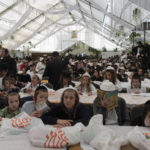 
              Orthodox Jewish children pray in a synagogue at the tomb of Rabbi Nachman, the great grandson of the founder of Hasidic movement, in the town of Uman, 200 kilometers (125 miles) south of Ukraine's capital Kiev, Ukraine, Sunday, Sept. 25, 2022. Thousands of Hasidic Jewish pilgrims flocked to central Ukraine to mark the Jewish new year Sunday, ignoring international travel warnings as Russia struck more targets from the air and mobilized its citizens to stem losses in the war that has entered its eighth month. (AP Photo/Efrem Lukatsky)
            