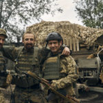 
              Ukrainian soldiers pose for a photo in Izium, Kharkiv region, Ukraine, Tuesday, Sept. 13, 2022. Ukrainian troops piled pressure on retreating Russian forces Tuesday, pressing deeper into occupied territory and sending more Kremlin troops fleeing ahead of the counteroffensive that has inflicted a stunning blow on Moscow's military prestige. (AP Photo/Kostiantyn Liberov)
            