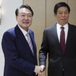 
              South Korean President Yoon Suk Yeol, left, shakes hands with Li Zhanshu, chairman of the standing committee of China's National People's Congress, at the presidential office in Seoul, South Korea, Friday, Sept. 16, 2022. (See Myung-gon/Yonhap via AP)
            