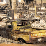 
              A scorched pickup truck sits in front of a Wakefield Avenue home destroyed by the Mill Fire on Saturday, Sept. 3, 2022, in Weed, Calif. (AP Photo/Noah Berger)
            