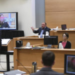 
              Conspiracy theorist Alex Jones is shown a photo of Judge Barbara Bellis with laser beams coming out of her eyes from his website during his testimony as Judge Bellis listens beside him, right, during the Sandy Hook defamation damages trial at Connecticut Superior Court in Waterbury, Conn. Thursday, Sept. 22, 2022. Jones was found liable last year by default for damages to plaintiffs without a trial, as punishment for what the judge called his repeated failures to turn over documents to their lawyers. The six-member jury is now deciding how much Jones and Free Speech Systems, Infowars’ parent company, should pay the families for defaming them and intentionally inflicting emotional distress. (Tyler Sizemore/Hearst Connecticut Media via AP, Pool)
            