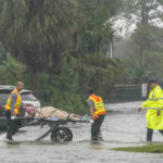 
              Authorities transport a person out of the Avante nursing home in the aftermath of Hurricane Ian, Thursday, Sept. 29, 2022, in Orlando, Fla. Hurricane Ian carved a path of destruction across Florida, trapping people in flooded homes, cutting off the only bridge to a barrier island, destroying a historic waterfront pier and knocking out power to 2.5 million people as it dumped rain over a huge area on Thursday. (AP Photo/John Raoux)
            
