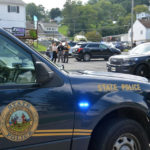 
              A heavy police presence is on scene of a Nutter Fort, W.Va. funeral home on Wednesday, Aug. 24, 2022, after an officer-involved shooting of a fugitive suspect occurred in the funeral home's parking lot. (Jonathan Weaver/The Exponent via AP)
            