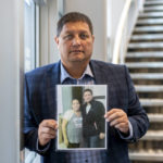 
              Mark Arcand, who's sister Bonnie Burns was killed during a series of violence attacks at James Smith Cree Nation holds a photo in Saskatoon, Wednesday, Sept. 7, 2022.   Myles Sanderson, 32, and his brother Damien, 30, are accused of killing 10 people and wounding 18 in a string of attacks across an Indigenous reserve and in the nearby town of Weldon. Damien was found dead Monday, and police were investigating whether his own brother killed him.  (Liam Richards/The Canadian Press via AP)
            