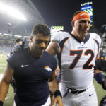 
              Denver Broncos quarterback Russell Wilson, left, walks off the field with offensive tackle Garett Bolles (72) after an NFL football game against the Seattle Seahawks, Monday, Sept. 12, 2022, in Seattle. The Seahawks won 17-16. (AP Photo/Stephen Brashear)
            