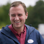 
              New Hampshire Republican 1st Congressional District Candidate Matt Mowers smiles while talking with voters and campaign volunteers, Tuesday, Sept. 13, 2022, during a stop at a polling station in Derry, N.H. (AP Photo/Charles Krupa)
            