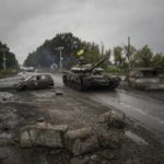 
              FILE - A Ukrainian tank drives past a former Russian checkpoint in the recently retaken area of Izium, Ukraine, Sept. 16, 2022. A swift Ukrainian counteroffensive earlier this month that forced Russian troops to retreat from broad swaths of the northeastern Kharkiv region has forced the Kremlin to rush absorbing Russia-held areas in Ukraine's east and south. (AP Photo/Evgeniy Maloletka, File)
            