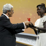 
              Festival president Robert Cicutto, left, presents director Alice Diop with the Lion of the Future - "Luigi De Laurentiis" Venice Award for a Debut Film for 'Saint Omar' at the closing ceremony of the 79th edition of the Venice Film Festival in Venice, Italy, Saturday, Sept. 10, 2022. (AP Photo/Domenico Stinellis)
            