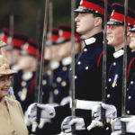 
              FILE - In this April 12, 2006 file photo Britain's Prince Harry, second from right, grins and his grandmother Queen Elizabeth II smiles, as she inspects the Sovereign's Parade at the Royal Military Academy in Sandhurst, England.  Queen Elizabeth II, Britain’s longest-reigning monarch and a rock of stability across much of a turbulent century, has died. She was 96. Buckingham Palace made the announcement in a statement on Thursday Sept. 8, 2022.(AP Photo/Dylan Martinez, pool)
            