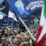 
              FILE - Right-wing party Brothers of Italy's leader Giorgia Meloni, center-right on stage, addresses a rally as she starts her political campaign ahead of Sept. 25 general elections, in Ancona, Italy, Tuesday, Aug. 23, 2022. The Brothers of Italy party has won the most votes in Italy’s national election. The party has its roots in the post-World War II neo-fascist Italian Social Movement. Giorgia Meloni has taken Brothers of Italy from a fringe far-right group to Italy’s biggest party. (AP Photo/Domenico Stinellis, File)
            