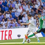 
              Real Madrid's Luka Modric, left is tackled by Betis' Alex Moreno during a Spanish La Liga soccer match between Real Madrid and Betis at the Santiago Bernabeu stadium in Madrid, Spain, Saturday, Sept. 3, 2022. (AP Photo/Pablo Garcia)
            