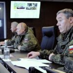 
              Russian President Vladimir Putin, center, flanked by General Staff chief, Gen. Valery Gerasimov, right, and Defense Minister Sergei Shogu attend the Vostok 2022 (East 2022) military exercise in fareastern Russia, outside Vladivostok, on Tuesday, Sept. 6, 2022. The weeklong exercise that began Thursday is intended to showcase growing defense ties between Russia and China and also demonstrate that Moscow has enough troops and equipment to conduct the massive drills even as its troops are engaged in military action in Ukraine. (Mikhail Klimentyev, Sputnik, Kremlin Pool Photo via AP)
            
