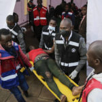 
              Medics treat the injured after people broke through barriers causing a stampede as they tried to force their way into Kasarani stadium where the inauguration of Kenya's new president William Ruto is due to take place later today, in Nairobi, Kenya Tuesday, Sept. 13, 2022. (AP Photo/Brian Inganga)
            