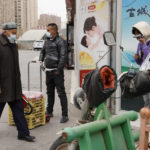 
              Residents wearing masks walk along the streets of Aksu in western China's Xinjiang region on Thursday, March 18, 2021. Residents of Ghulja, a city in China’s far west Xinjiang region say they are experiencing hunger, forced quarantines and dwindling supplies of medicine and daily necessities after more than 40 days in a virus lockdown. (AP Photo/Ng Han Guan, File)
            