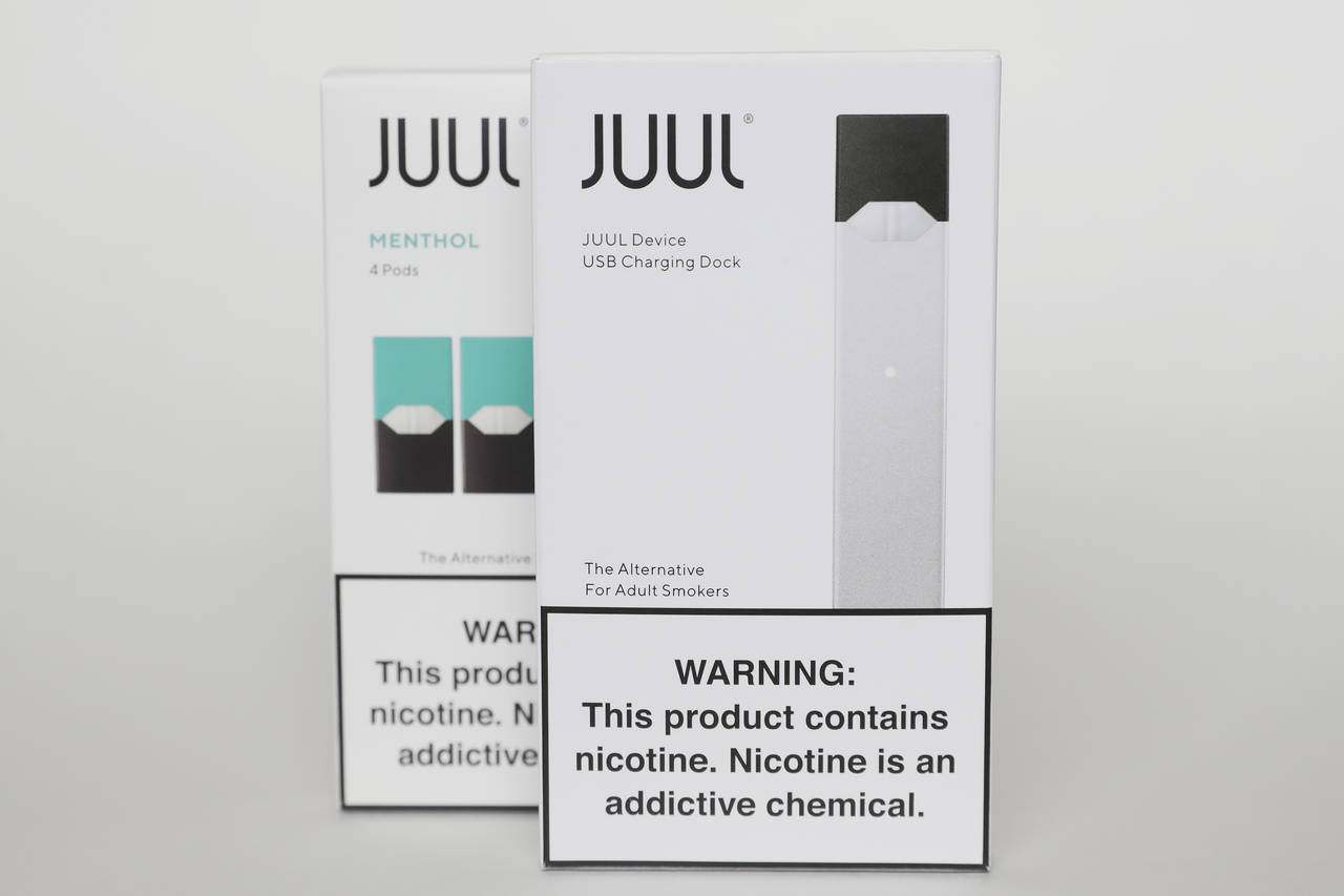 FILE - Packaging for an electronic cigarette and menthol pods from Juul Labs is displayed on Feb. 2...