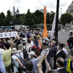 
              People protest against a state funeral for Japan's former Prime Minister Shinzo Abe, near the parliament in Tokyo Tuesday, Sept. 27, 2022. The rare and controversial state funeral for assassinated Abe began Tuesday in tense Japan where the event for one of the country's most divisive leaders has deeply split public opinion. (Kyodo News via AP)
            