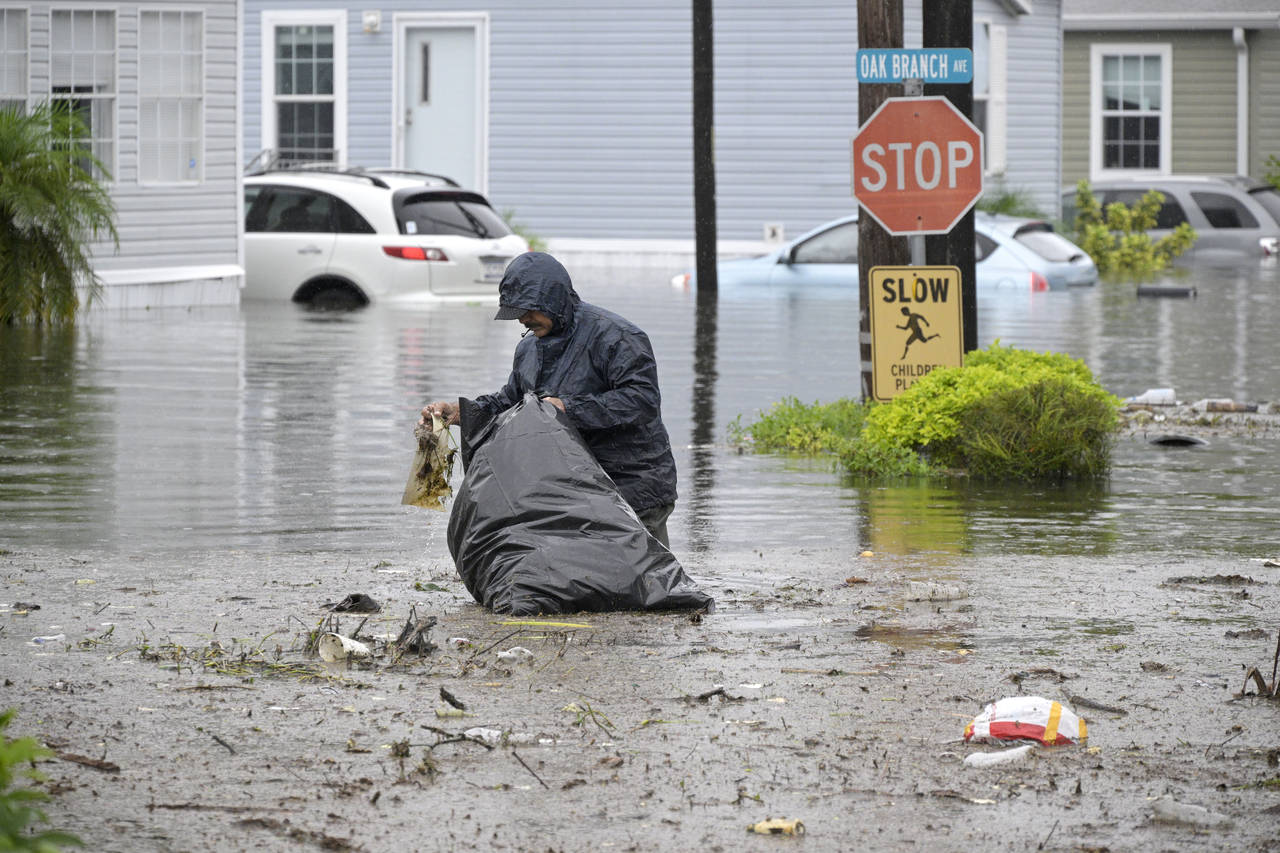 Resident Alex Calderon removes debris in his flooded neighborhood in the aftermath of Hurricane Ian...