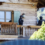 
              Masked police officers stand on a balcony of a house belonging to Russian oligarch Usmanov during a raid in Rottach-Egern, Germany, Wednesday, Sept.21, 2022. In connection with investigations against a Russian for violation of the Foreign Trade and Payments Act, 24 houses and apartments were searched across Germany on Wednesday. (Matthias Balk/dpa via AP)
            