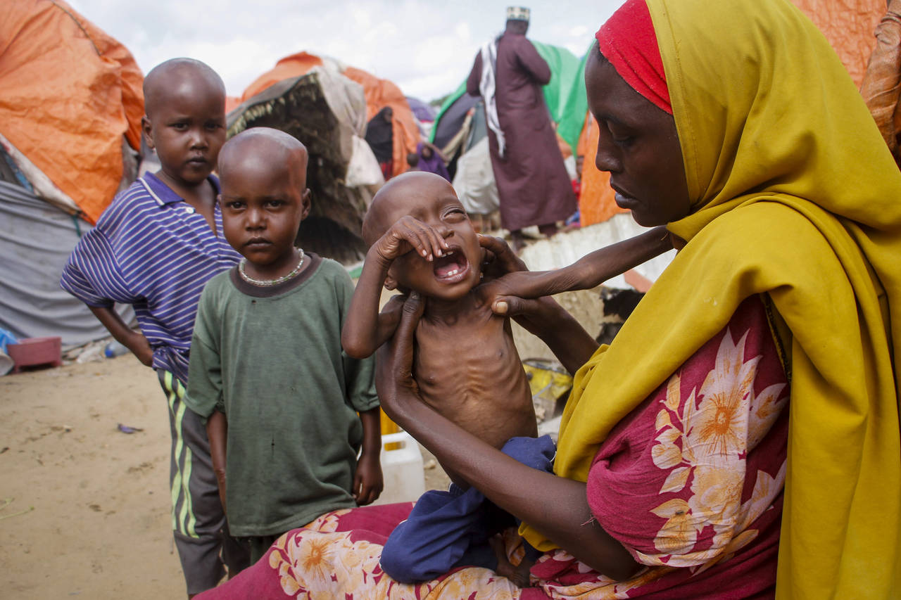 Maryan Madey, who fled the drought-stricken Lower Shabelle region, holds her malnourished daughter ...