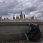 
              A homeless man rests in a queue with people waiting to pay their respects to the late Queen Elizabeth II during the Lying-in State, outside Westminster Hall in London, Thursday, Sept. 15, 2022. The Queen will lie in state in Westminster Hall for four full days before her funeral on Monday Sept. 19.(AP Photo/Nariman El-Mofty)
            