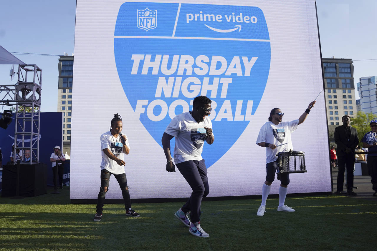 FILE - Robert "Bojo" Ackah, center, and Fik-Shun, left, perform during the announcement of the firs...