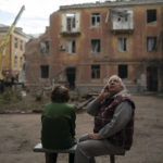 
              Raisa Smielkova, 75, looks up as she sits in front of the site where firefighters work to extinguish a fire as they look for potential victims after a Russian attack that heavily damaged a residential building in Sloviansk, Ukraine, Wednesday, Sept. 7, 2022. Smielkova was sleeping at the time of the explosion. "You would be a fool not to be scared by this," she says. "If someone asks, I say yes, I am scared." (AP Photo/Leo Correa)
            