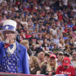
              A supporter dressed as Uncle Sam shows his support while Rep. Marjorie Taylor Greene speaks ahead of former President Donald Trump at a rally in Wilkes-Barre, Pa., Saturday, Sept. 3, 2022. (AP Photo/Mary Altaffer)
            