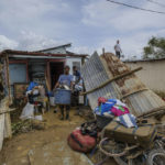 
              Neighbors work to recover their belongings that were saved from the flooding caused by Hurricane Fiona at the Los Sotos neighborhood in Higüey, Dominican Republic, Tuesday, Sept. 20, 2022. (AP Photo/Ricardo Hernandez)
            