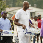 
              Former NBA basketball player Erick Dampier, joins other volunteers in carrying cases of water to Jackson, Miss., residents during a drive-thru water distribution, Sept. 7, 2022. A boil-water advisory has been lifted for Mississippi's capital, and the state will stop handing out free bottled water on Saturday. But the crisis isn't over. Water pressure still hasn't been fully restored in Jackson, and some residents say their tap water still comes out looking dirty and smelling like sewage. (AP Photo/Rogelio V. Solis)
            