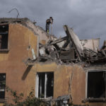 
              A firefighter works to extinguish a fire as he looks for potential victims after a Russian attack that heavily damaged a residential building in Sloviansk, Ukraine, Wednesday, Sept. 7, 2022. (AP Photo/Leo Correa)
            