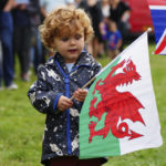 
              Elliot Gray, 2, waves the Welsh national flag ahead of the Accession Proclamation Ceremony at Cardiff Castle, Wales, publicly proclaiming King Charles III as the new monarch, Sunday Sept. 11, 2022. (Ben Birchall/PA via AP)
            