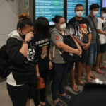 
              Malaysian youths rescued from human traffickers in Cambodia arrive at the Kuala Lumpur Airport Terminal in Sepang, Thursday, Oct. 6, 2022. Another 21 Malaysians rescued from human traffickers in Cambodia and Laos returned to the country Thursday, as the government intensified effort to detect scam victims stranded abroad. (AP Photo/Vincent Thian)
            
