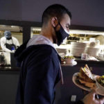 
              FILE - Bartender Denis Angelov carries plates of food from the kitchen, behind, at Tin Pan Alley restaurant, Tuesday, April 6, 2021, in Provincetown, Mass. The number of available jobs in the U.S. plummeted in August 2022 compared with July as businesses grow less desperate for workers, a trend that could cool chronically high inflation.   (AP Photo/Steven Senne, File)
            