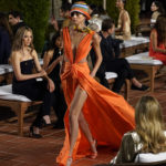 
              A model walks through the audience at the Ralph Lauren Spring 2023 Fashion Experience on Thursday, Oct. 13, 2022, at the Huntington Gardens in Pasadena, Calif. (AP Photo/Chris Pizzello)
            