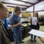 
              Torrance County deputy clerk Silvia Chavez, center, shows a ballot sample to local candidates and partisan officers during a ballot-counting machines testing in Estancia, N.M., Sept. 29, 2022. (AP Photo/Andres Leighton)
            