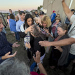 
              Amanda Grace of Ark of Grace Ministries and a group of people gather in prayer around a woman for the laying of hands during the ReAwaken America Tour at Cornerstone Church in Batavia, N.Y., Friday, Aug. 12, 2022. “This is war, and you have to have a different mindset for that,” Grace says. “You pray for your family, you pray for your friends, you love them. But you have to understand that these rulers are after you. They’re out to destroy you and your line, and everything you’re going to birth forth through your line for the Kingdom of God.” (AP Photo/Carolyn Kaster)
            